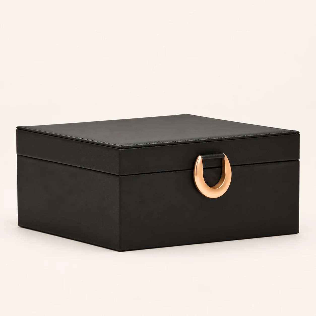 Black solid-lid jewelry box with a ring-shaped front clasp and no drawers
